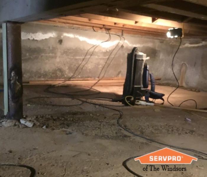 Crawl Space Wood framing cleaning equipment in back and emergency light