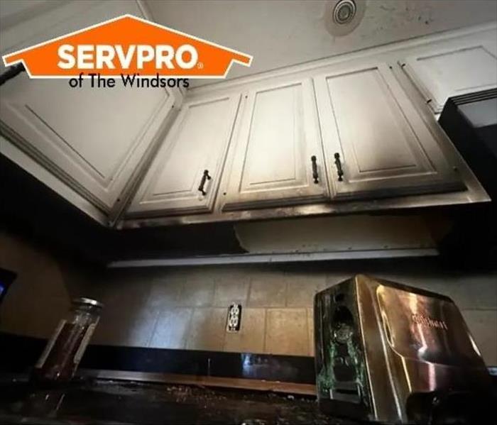 house fire in kitchen, white cabinets burned, servpro logo, counter, burnt toaster in south windsor