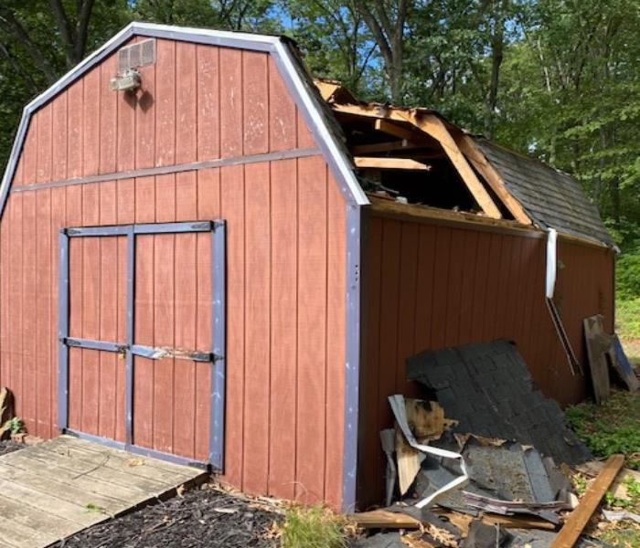 shed in yard, burn damage, roof missing, lawn, red wood, south windsor, floor lights servpro near me