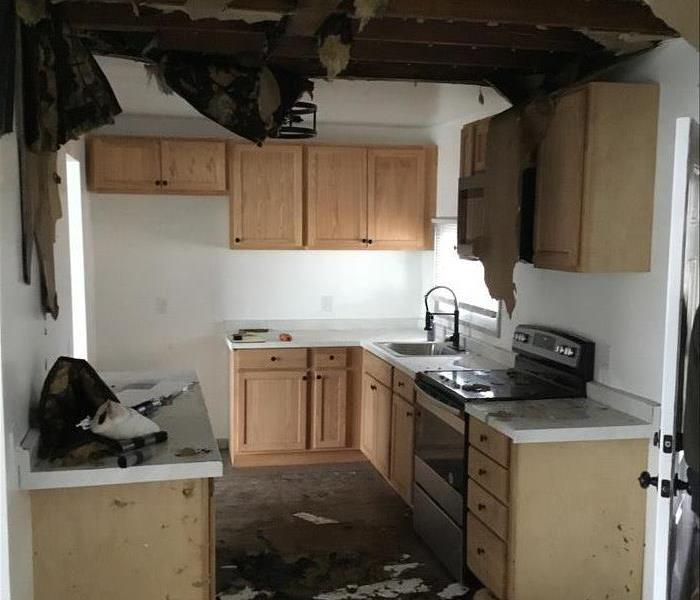 kitchen in Windsor, CT after water damage, wet floors and cabinets, fallen ceiling
