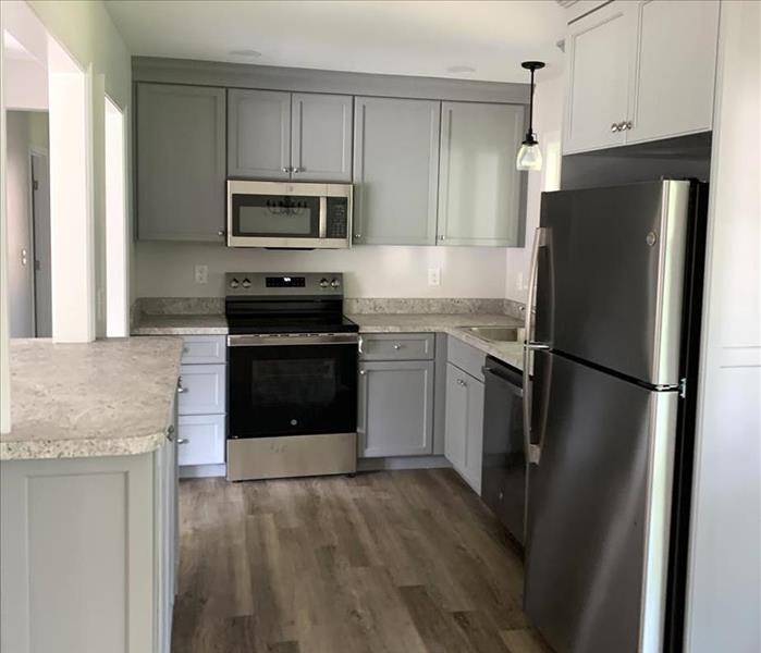 Kitchen in Windsor after mitigation - new floors, cabinets, appliances, cleaned kitchen