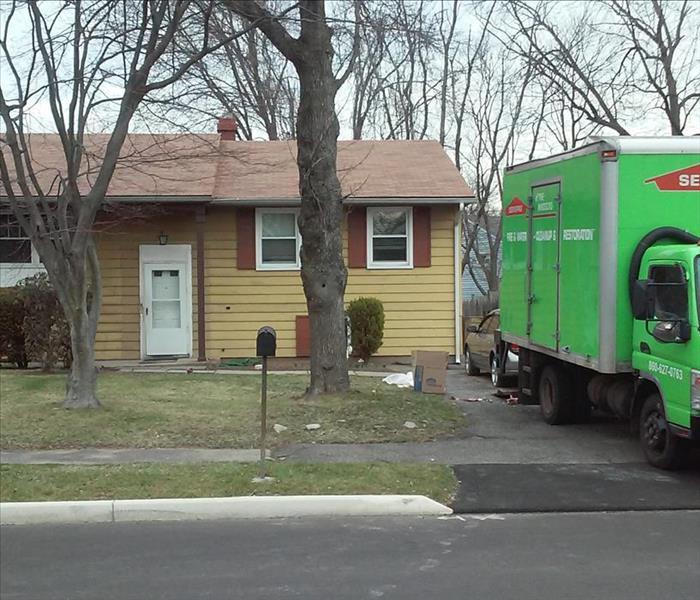 SERVPRO in windsor ct, SERVPRO of the windsors box truck, in driveway of yellow two story home, front lawn, SERVPRO ct, water