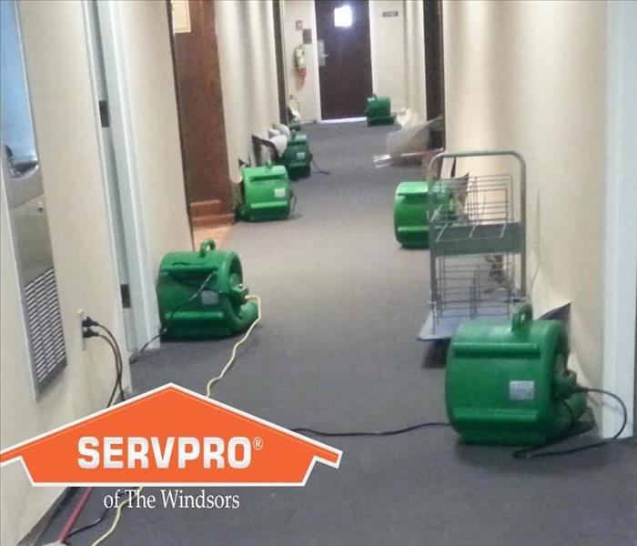 Commercial hallway after water damage in windsor ct, air movers in place, SERVPRO logo, SERVRO ct