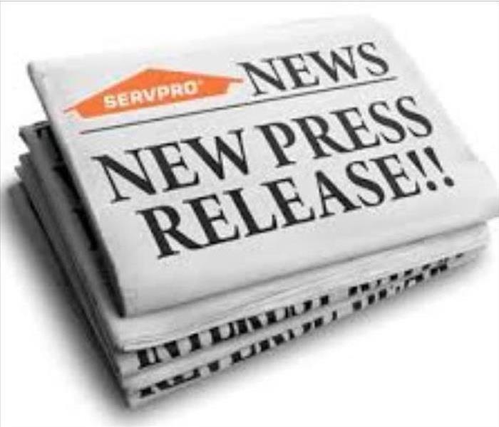 White folded up pile of news papers, orange SERVPRO logo is on newspaper & newspaper reads news, new press release.