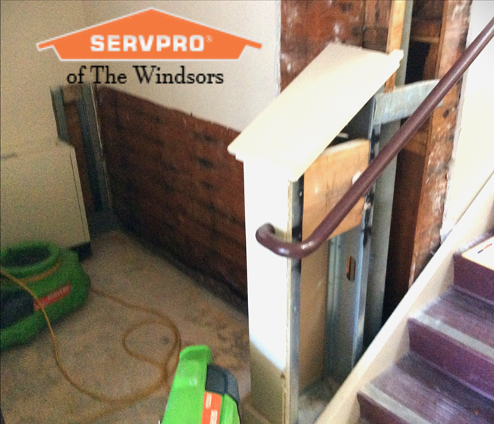 church water damage, SERVPRO of The Windsors, wall with area removed, drying equipment , stairs, SERVPRO logo