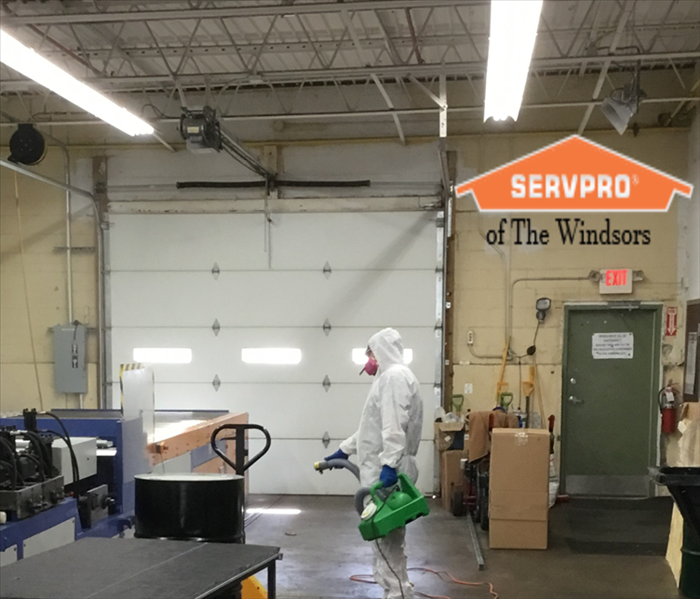 warehouse in east windsor ct, tech in PPE, fog machine, open door, SERVPRO logo