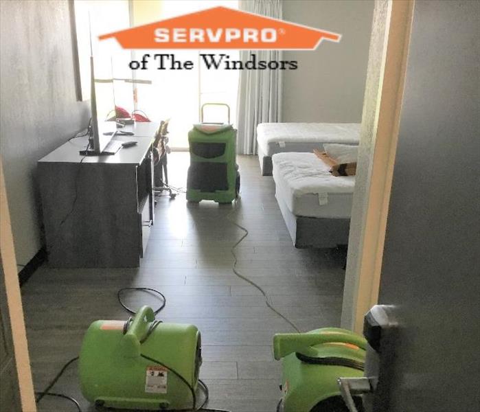 hotel room in windsor locks, water damge, servpro drying equipment, servpro logo, beds, chair, wood floors, sun shine