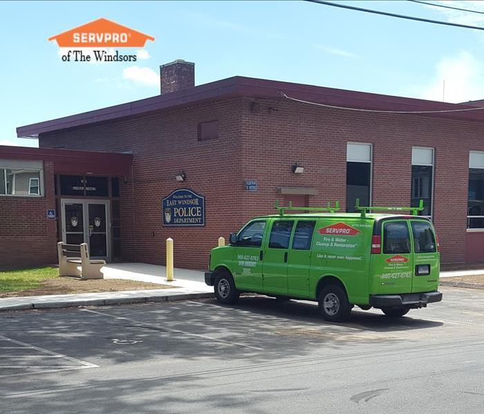Green SERVPRO of The Windsors truck parked in front of brick building that reads East Windsor Police Department