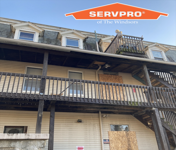 back side of apartment building, SERVPRO logo, windows boarded