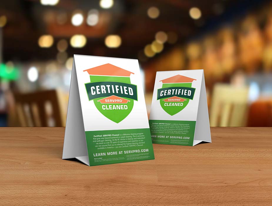 Commerical table with Certified: SERVPRO Cleaned program tabletops placed